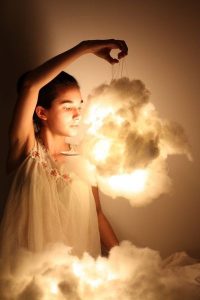 Girl holding a cotton cloud lamp Girl holding a cotton cloud lamp