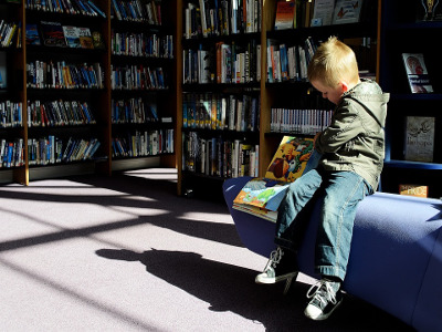 Boy reading in a library